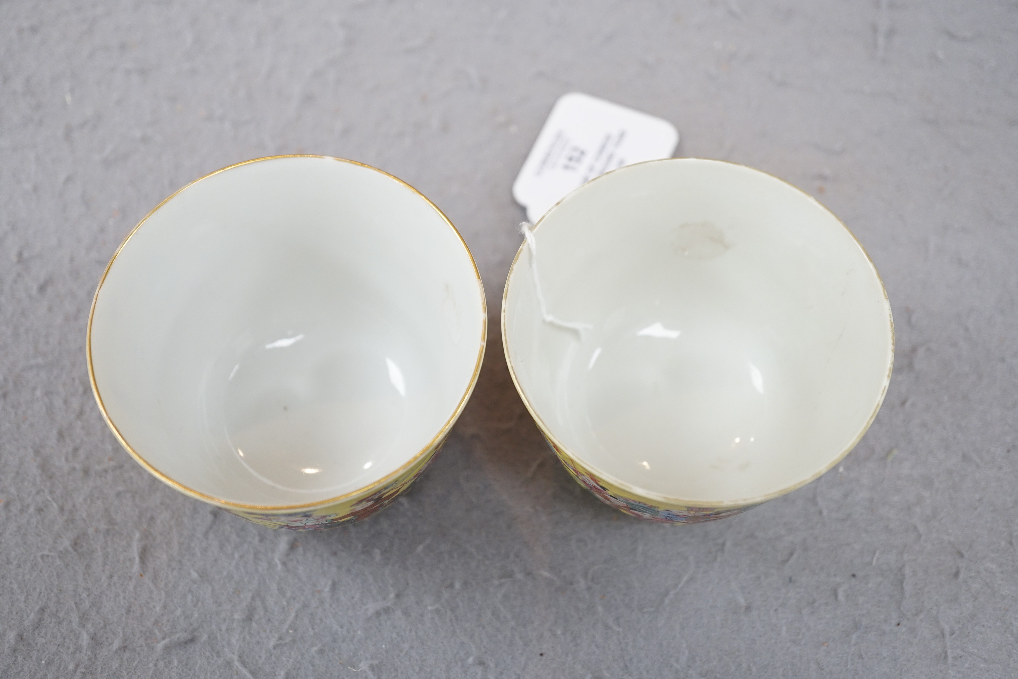 A pair of Chinese yellow ground 'Hundred Boys’ cups, 19th century, 6.5cm high 8.5cm diameter